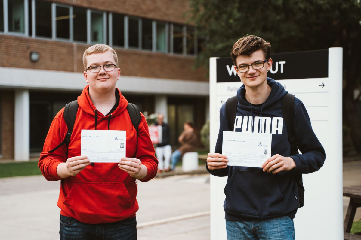 Two students celebrate their GCSE results