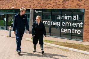 Two students outside the animal management centre at Merrist Wood College