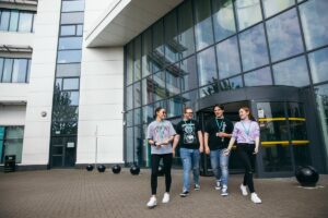 Four students walking out of Bracknell and Wokingham College