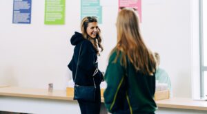 Two female students looking at each other